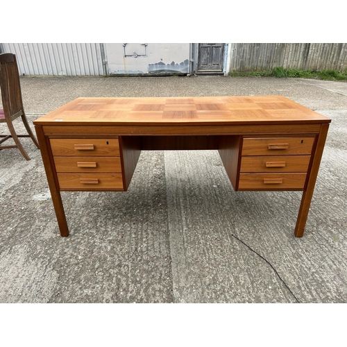 24 - A mid century teak kneehole desk labelled MADE IN NORWAY 150x77x74