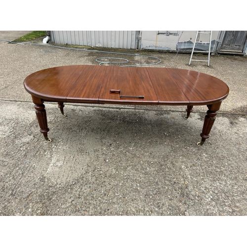 248 - A Victorian mahogany oval extending dining table with three leaves, extending to a maximum of 238x12... 