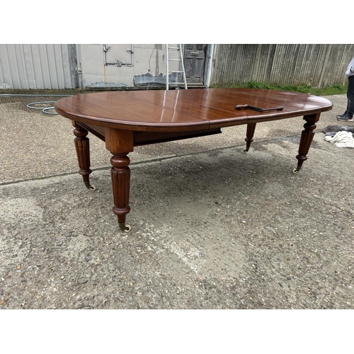 248 - A Victorian mahogany oval extending dining table with three leaves, extending to a maximum of 238x12... 