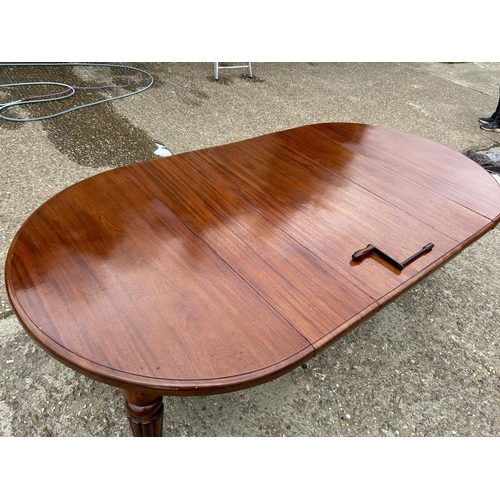 248 - A Victorian mahogany oval extending dining table with three leaves, extending to a maximum of 238x12... 