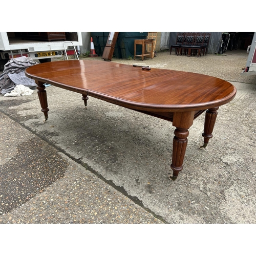 248 - A Victorian mahogany oval extending dining table with three leaves, extending to a maximum of 238x12... 