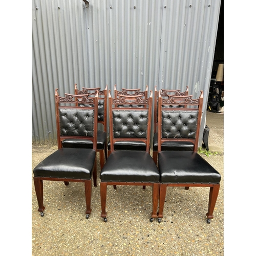 249 - An ornate  set of six mahogany dining chairs with black leather seats