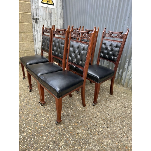 249 - An ornate  set of six mahogany dining chairs with black leather seats