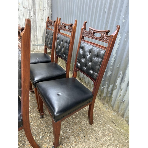 249 - An ornate  set of six mahogany dining chairs with black leather seats