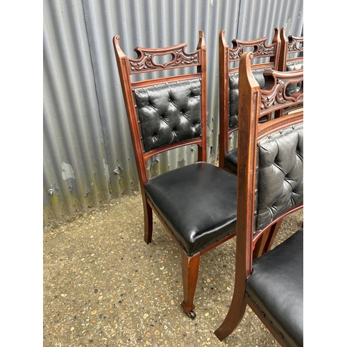 249 - An ornate  set of six mahogany dining chairs with black leather seats