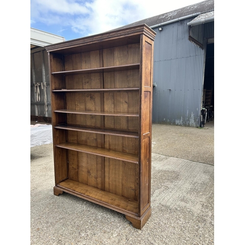 252 - A large reproduction oak open fromted bookcase with adjustable shelves 160x31x244