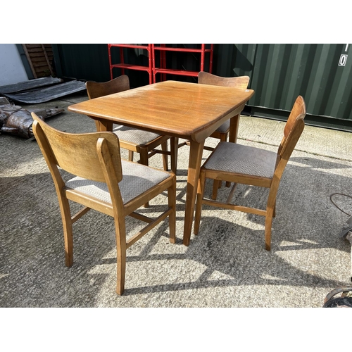 294 - A mid century retro dining table with four chairs and extension leaf