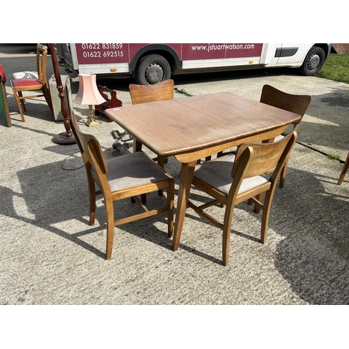 294 - A mid century retro dining table with four chairs and extension leaf