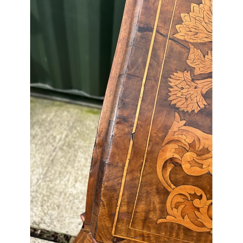 331 - An early Dutch marquetry inlaid bureau with fitted interior writing well and three long drawers rais... 