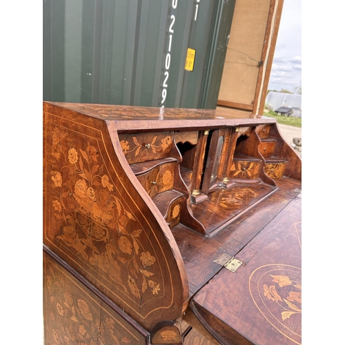 331 - An early Dutch marquetry inlaid bureau with fitted interior writing well and three long drawers rais... 