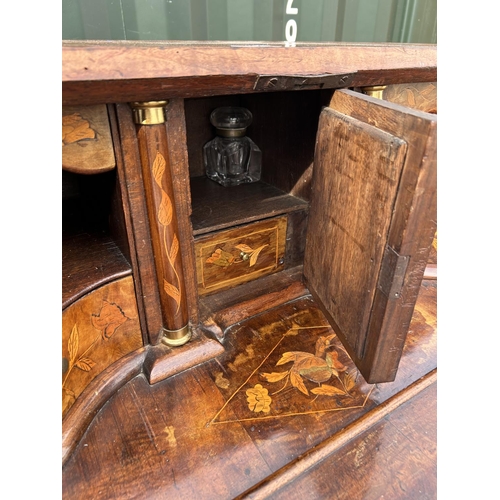 331 - An early Dutch marquetry inlaid bureau with fitted interior writing well and three long drawers rais... 