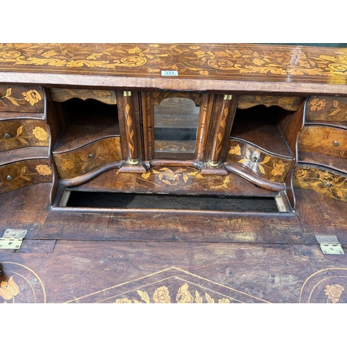 331 - An early Dutch marquetry inlaid bureau with fitted interior writing well and three long drawers rais... 