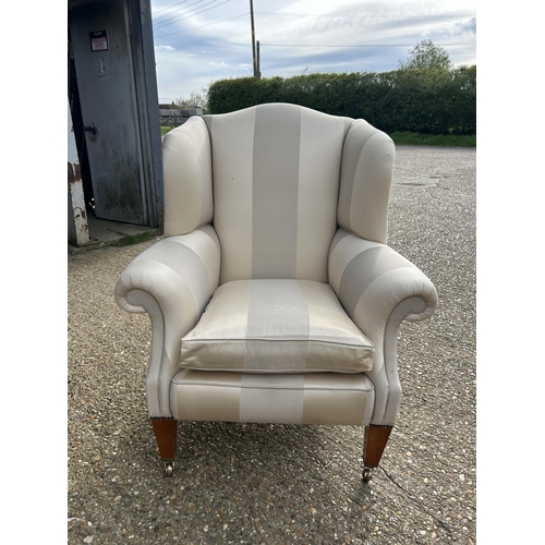 352 - A good quality cream striped wing back armchair by Duresta