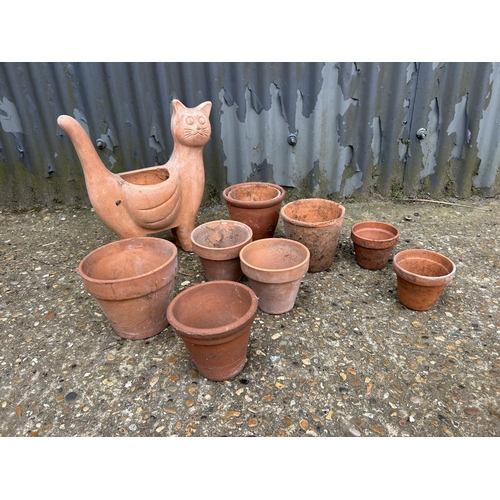 45 - A terracotta cat and 10 pots