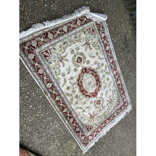 56 - A red and cream rug 180x125