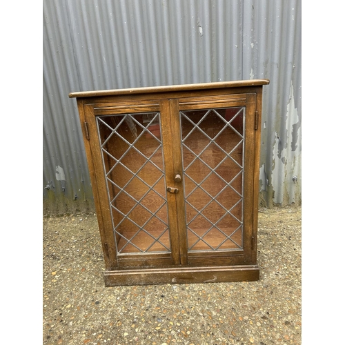 59 - An old charm leaded oak cabinet 73x30x90