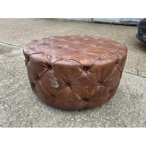 65 - A tan brown leather swivel chesterfield stool 100cm diameter x 50 high