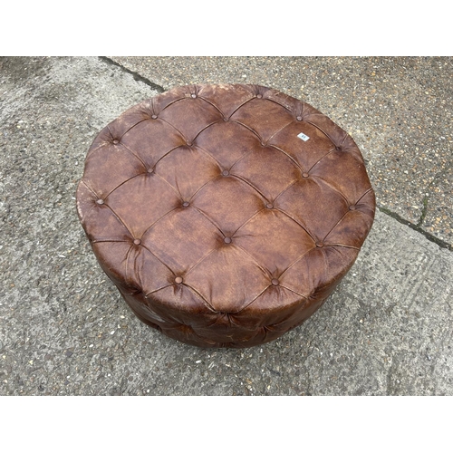 65 - A tan brown leather swivel chesterfield stool 100cm diameter x 50 high