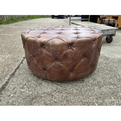 65 - A tan brown leather swivel chesterfield stool 100cm diameter x 50 high