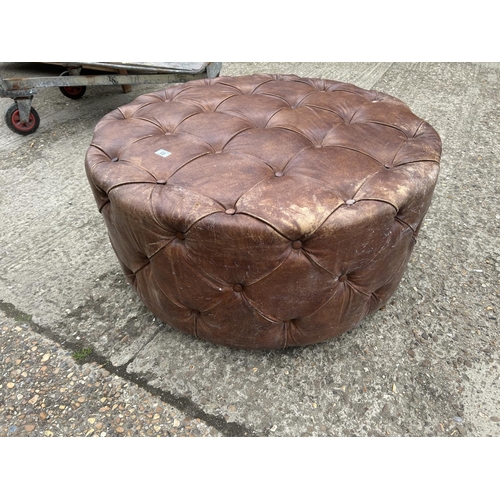 65 - A tan brown leather swivel chesterfield stool 100cm diameter x 50 high