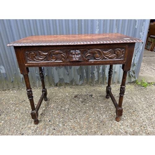 68 - A carved oak single drawer table 92x45 x80