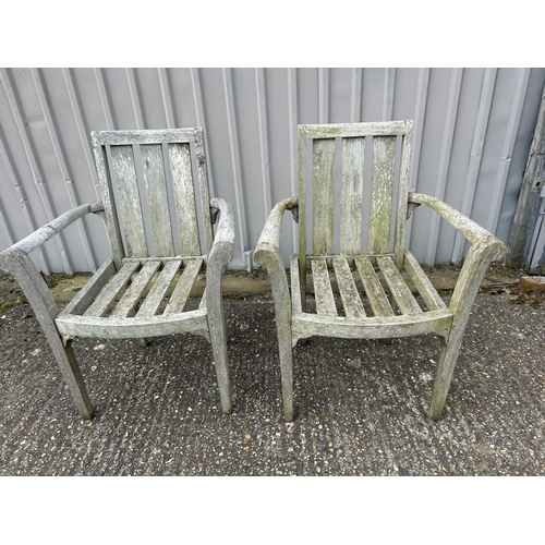 72 - A pair of hardwood garden carver chairs