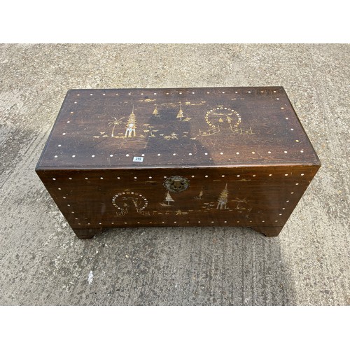 259 - A large oriental camphor wood blanket box trunk with mother of pearl inlay 112x55x60