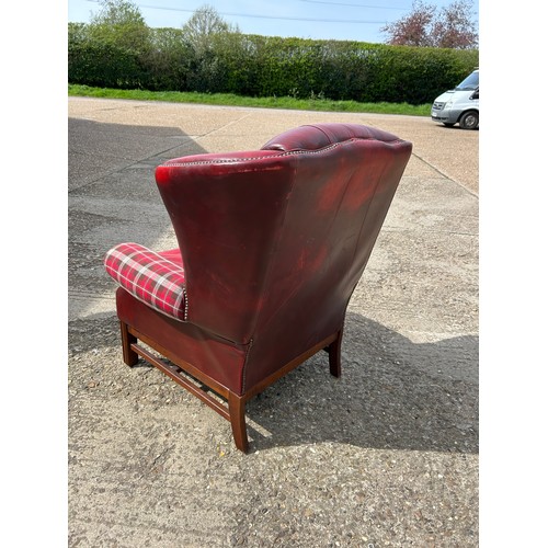 260 - A red leather chesterfield wing back chair with tartan pattern arm rests