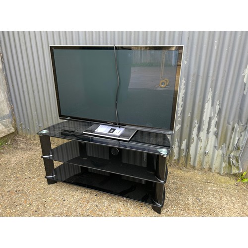 277 - A 42inch Panasonic tv with lead, remote and manual on modern black glass stand