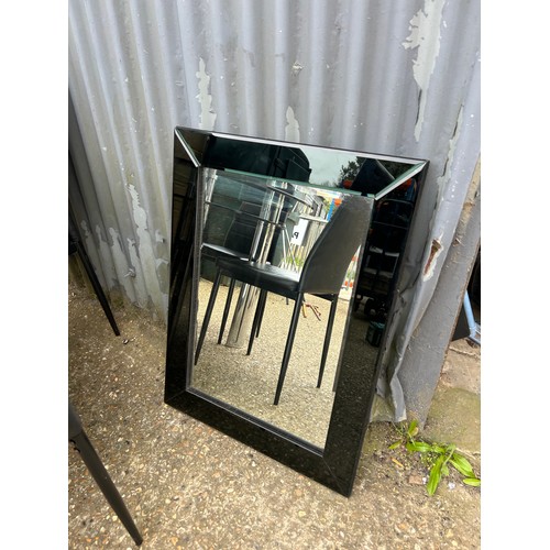 188 - A modern black glass top table 110cm together with four chairs and matching wall mirror