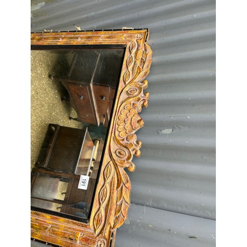 191 - A gold gilt and black mirror 77x110