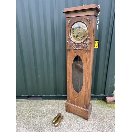 90D - An arts and crafts style oak long case  clock with pendulum and weights