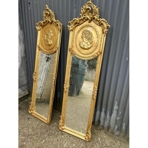 198D - A pair of decorative gold gilt framed halfway mirrors with ladies facing one another 160cm tall