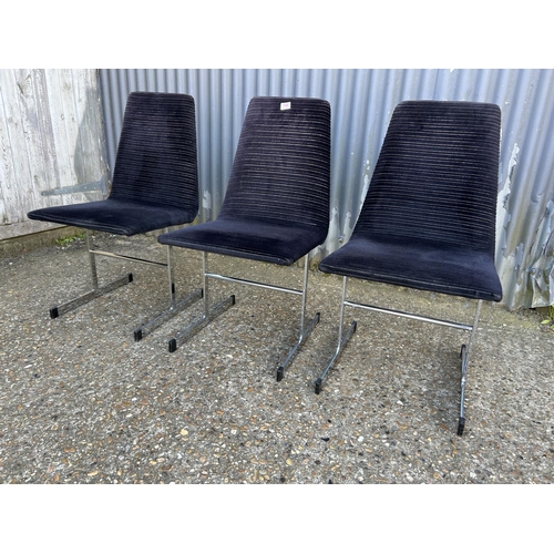 100 - A set of three pieff mid century dining chairs, black upholstered  on chrome supports