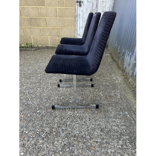 100 - A set of three pieff mid century dining chairs, black upholstered  on chrome supports