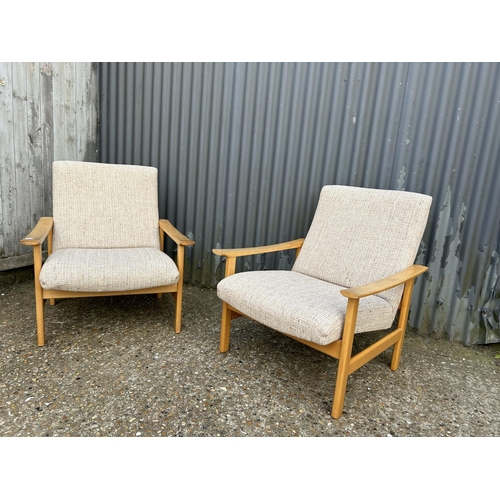 109 - A pair of mid century lounge arm chairs with oatmeal pattern upholstery