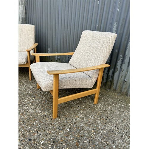 109 - A pair of mid century lounge arm chairs with oatmeal pattern upholstery