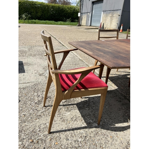 113 - A mid century extending teak extending  dining table and six chairs by MCINTOSH