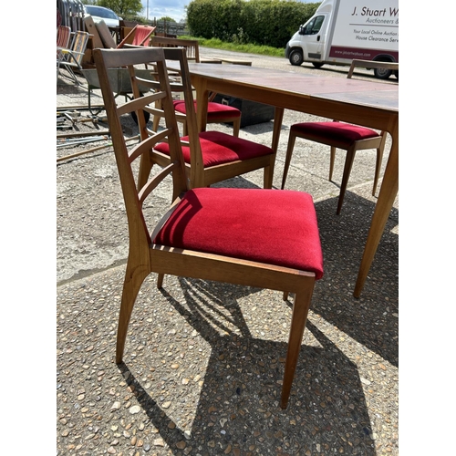 113 - A mid century extending teak extending  dining table and six chairs by MCINTOSH