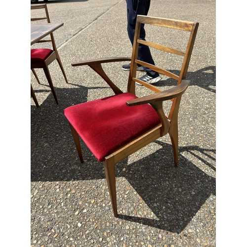 113 - A mid century extending teak extending  dining table and six chairs by MCINTOSH