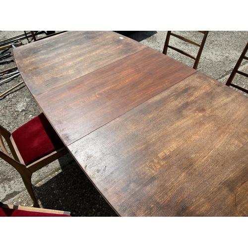 113 - A mid century extending teak extending  dining table and six chairs by MCINTOSH