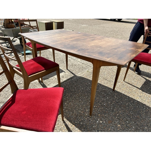 113 - A mid century extending teak extending  dining table and six chairs by MCINTOSH