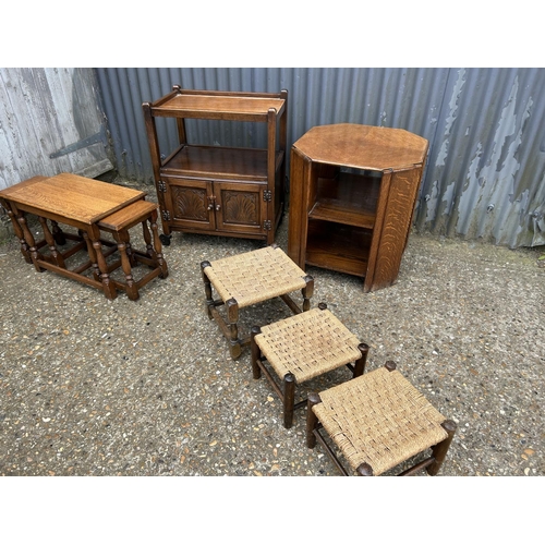 119 - An oak trolley, oak nest of three, three stools and a book table