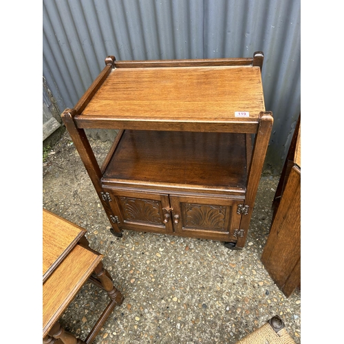 119 - An oak trolley, oak nest of three, three stools and a book table