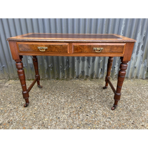 120 - An Edwardian mahogany two drawer table with leather top