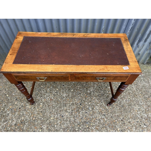 120 - An Edwardian mahogany two drawer table with leather top