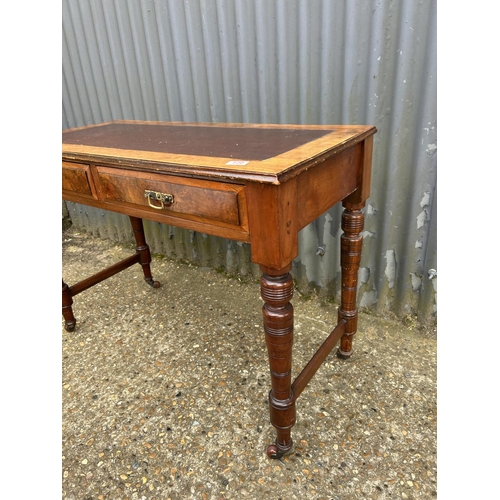 120 - An Edwardian mahogany two drawer table with leather top