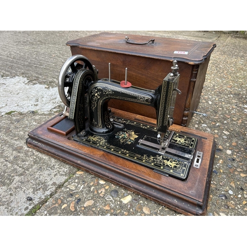 124 - A cased singer sewing machine