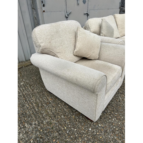 130 - A modern beige upholstered three piece lounge suite consisting of two seater sofa and two chairs