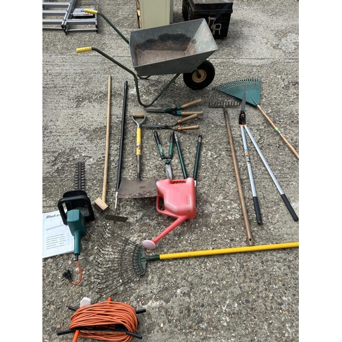 132 - Wheelbarrow, hedger cutter and garden tools